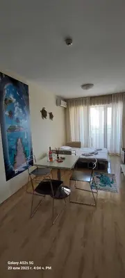 a living room with a table and a couch at Sunrise Apartment 14 in Obzor