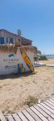 a surfboard leaned up against a building on the beach at Sunrise Apartment 14 in Obzor