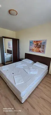 a bedroom with a large bed with white sheets at Sunrise Apartment 14 in Obzor