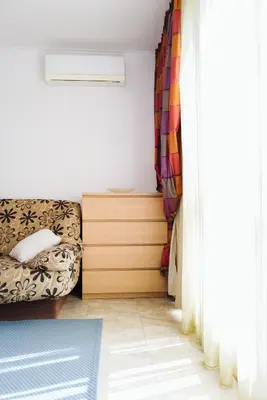 a living room with a couch and a window at Mirage Collective in Nesebar