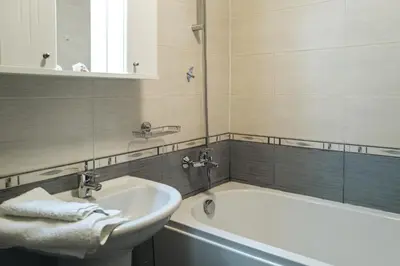 a bathroom with a sink and a bath tub at Mirage Collective in Nesebar