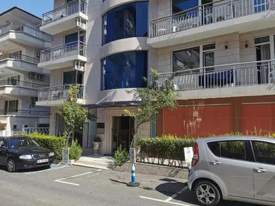 a car parked in a parking lot in front of a building at Alexandrov Residence Studio in Nesebar