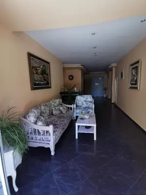 a living room with a couch and two chairs at Alexandrov Residence Studio in Nesebar