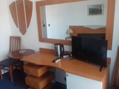 a room with a desk with a television on it at Alexandrov Residence Studio in Nesebar