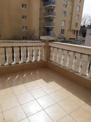 a balcony with birds on the floor of a building at Сънсет резорт Поморие in Pomorie