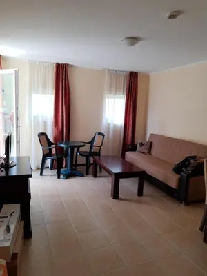 a living room with a couch and a table at Сънсет резорт Поморие in Pomorie