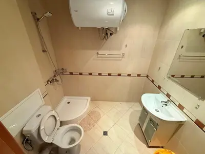 a bathroom with a toilet and a sink at South Beach Vigo Studio in Nesebar