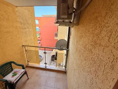 a view of a balcony with a chair and a window at South Beach Vigo Studio in Nesebar