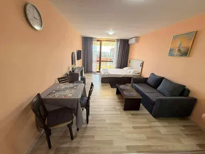a living room with a couch and a bed at Panorama Vigo Studio in Nesebar