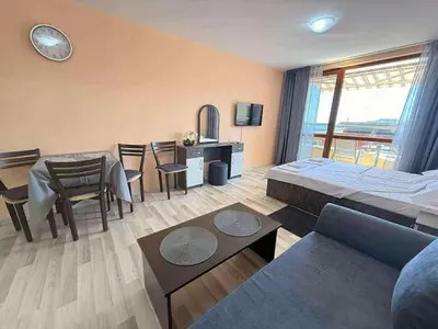 a living room with a bed and a dining room at Panorama Vigo Studio in Nesebar