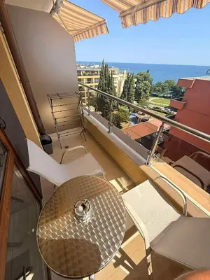 a balcony with a table and chairs on a balcony at Panorama Vigo Studio in Nesebar