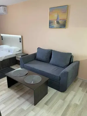 a living room with a couch and a bed at Panorama Vigo Studio in Nesebar