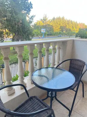 a table and two chairs on a balcony at Royal Sun - Vaio - 1BR Apt with Balcony in Sunny Beach