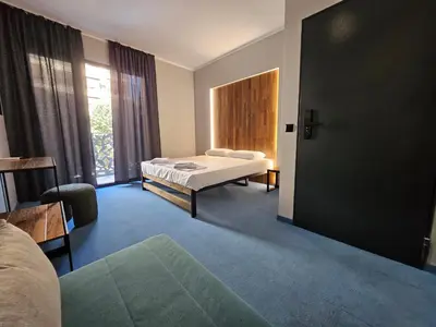 a large room with a bed and a window at O'clock bed & SPA in Burgas City