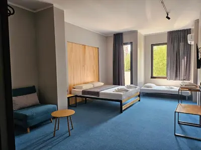 a room with two beds and a couch at O'clock bed & SPA in Burgas City