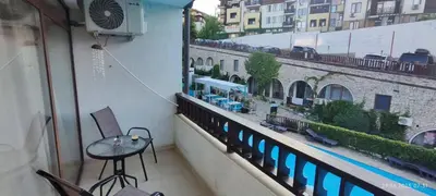 a balcony with a table and chairs on a building at Свети Влас Етъра1 in Sveti Vlas