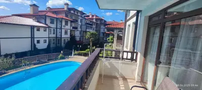 a balcony with a swimming pool and buildings at Свети Влас Етъра1 in Sveti Vlas