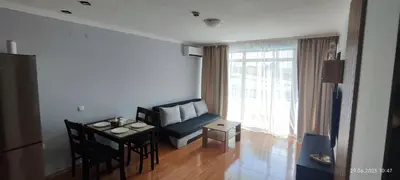 a living room with a couch and a table at Свети Влас Етъра1 in Sveti Vlas