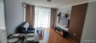 a living room with a table and a dining room at Свети Влас Етъра1 in Sveti Vlas