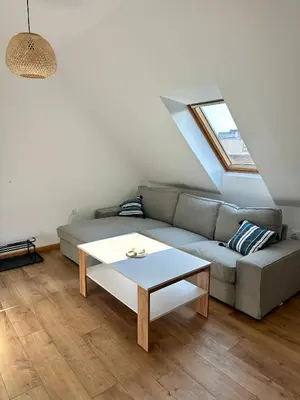 a living room with a couch and a table at Гнездото l The Nest in Burgas City