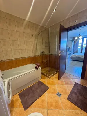 a bathroom with a shower and a bath tub at Каса Реал апартамент с 2 спальнями in Sveti Vlas