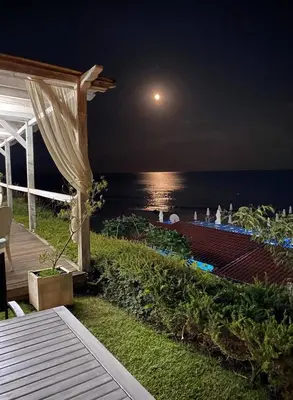 a view of the ocean at night from a resort at Каса Реал апартамент с 2 спальнями in Sveti Vlas