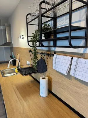 a kitchen with a counter with a sink and towels at Ипанемма апартамент с 1 спальней in Sveti Vlas