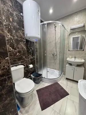a bathroom with a toilet and a shower and a sink at Ипанемма апартамент с 1 спальней in Sveti Vlas