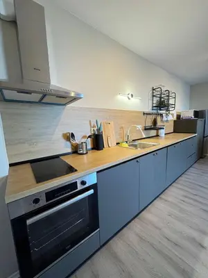 a kitchen with a sink and a stove top oven at Ипанемма апартамент с 1 спальней in Sveti Vlas