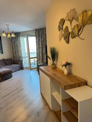 a living room with a counter and a living room with a couch at Ипанемма апартамент с 1 спальней in Sveti Vlas