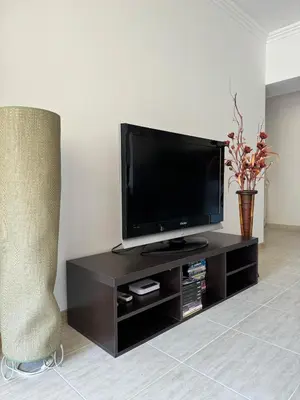 a black entertainment center with a flat screen tv at Arena Apart in Sveti Vlas