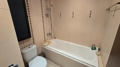 a bathroom with a white tub and a toilet at Green Life Sozopol 80m2 in Sozopol