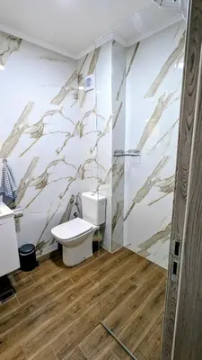 a bathroom with a toilet and a glass shower at Elegant studio - 100 m from Smokinya Beach by Flat Mаnager in Sozopol