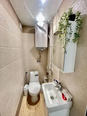 a small bathroom with a toilet and a sink at The Secret Tale in Varna City