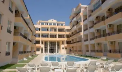 a swimming pool in front of a large building at SUN LIGHT Slnečné pobrežie in Sunny Beach