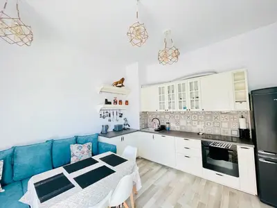 a kitchen with a blue couch and a table at 2BR Vintage Residence - free parking in Varna City
