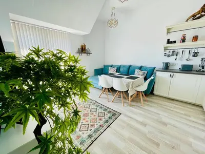 a kitchen and a living room with a table and chairs at 2BR Vintage Residence - free parking in Varna City