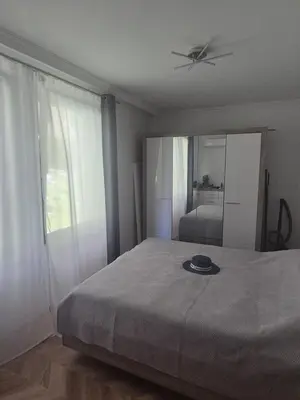 a bedroom with a bed with a ceiling fan and a mirror at Etara 4 in Sveti Vlas