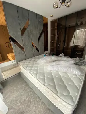 a large white bed in a room with a wall at Sweet Home 9 in Sunny Beach