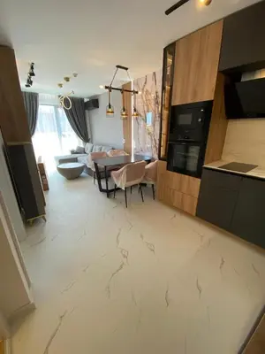 a kitchen and living room with a table and a couch at Sweet Home 9 in Sunny Beach
