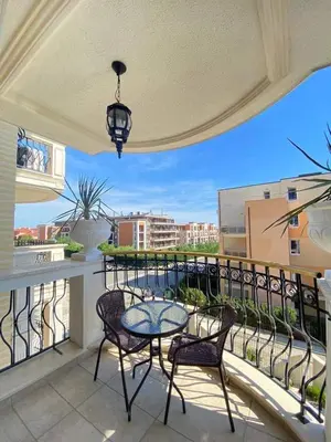 a balcony with a table and chairs and a view at Harmony 20 in Sveti Vlas