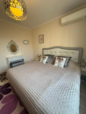 a bedroom with a large bed with two pillows at Эстебан с 2 спальнями in Nesebar