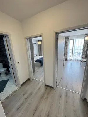 an empty living room with two doors and a hallway at Ипанемма с 1 спальней корпус А in Sveti Vlas