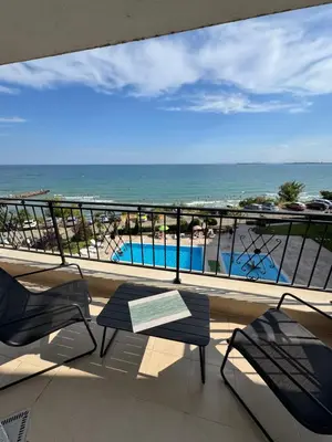a balcony with chairs and a view of the beach at Ипанемма с 1 спальней корпус А in Sveti Vlas
