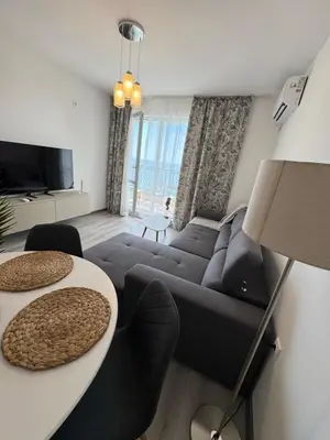 a living room with a couch and a table at Ипанемма с 1 спальней корпус А in Sveti Vlas