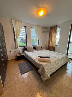 a bedroom with a large bed with two pillows on it at Kombani 3 in Sveti Vlas