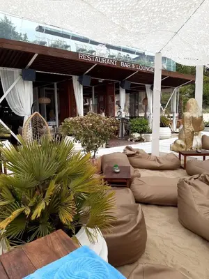 a restaurant bar and lounge with couches and tables at Kombani 3 in Sveti Vlas