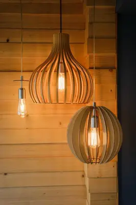 three lights hanging from a wooden wall at Sam Centre Harmony 1-Bedroom in Burgas City