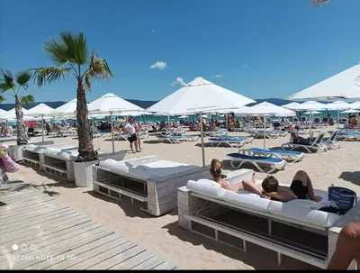 a group of people laying on the beach at Rainbow 2 Aparthotel Complex in Sunny Beach