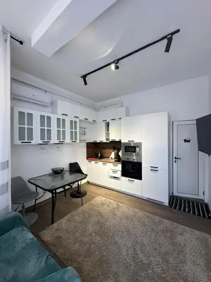 a living room with a table and a kitchen at Apartment in Sunny Fort in Sunny Beach